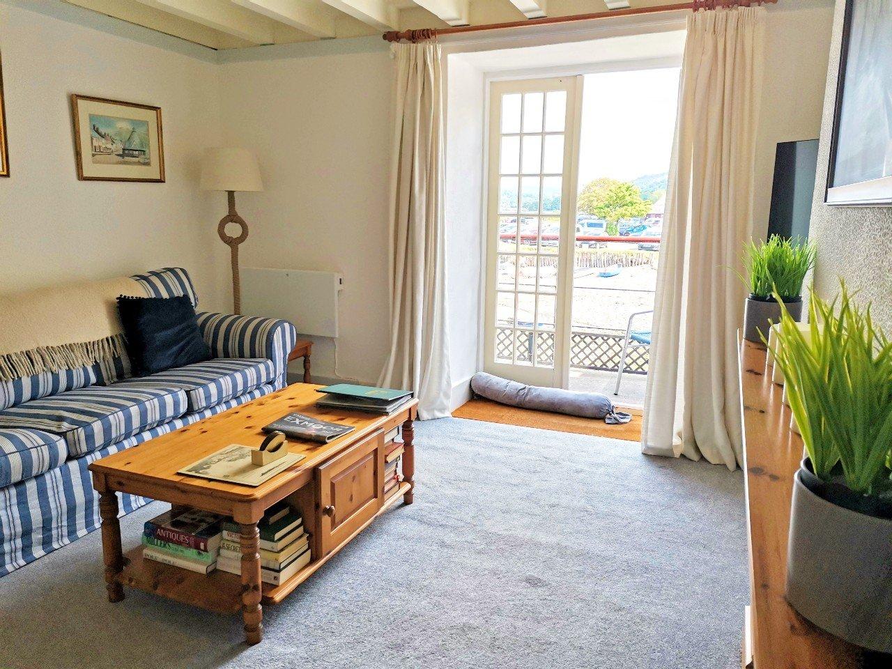 Harbour House Apartment Porlock Weir sitting room with french doors onto balcony overlooking the habour!