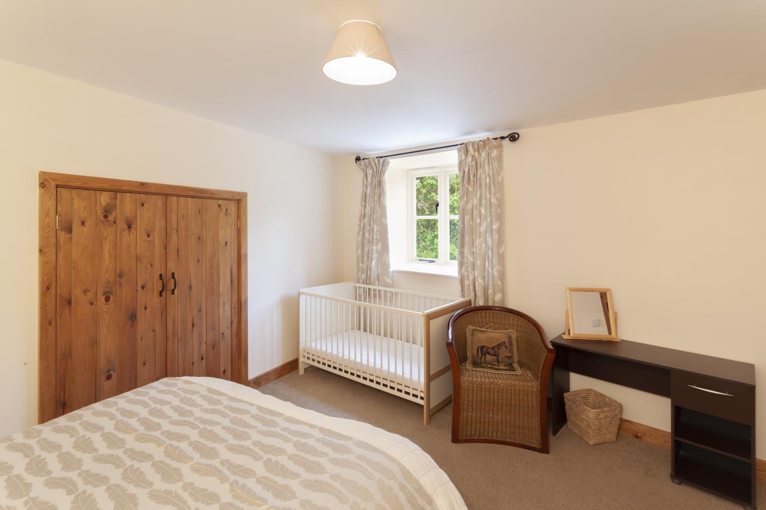 Double bedroom at The Mill House with cot