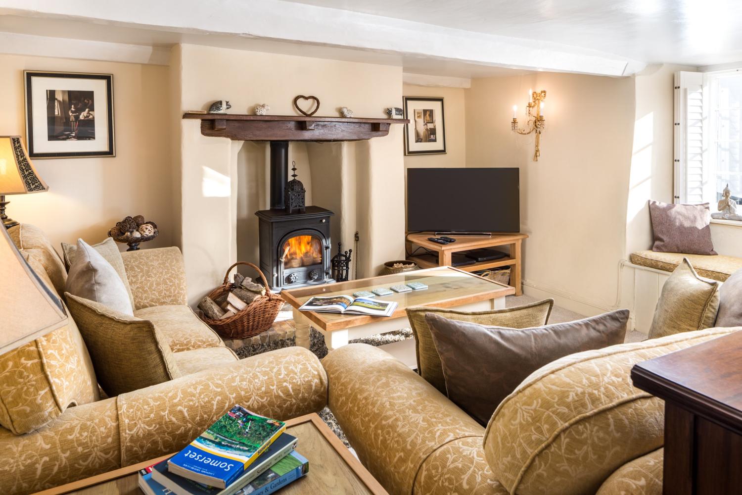 The living room has a wood burning stove and plenty of seating for everyone.
