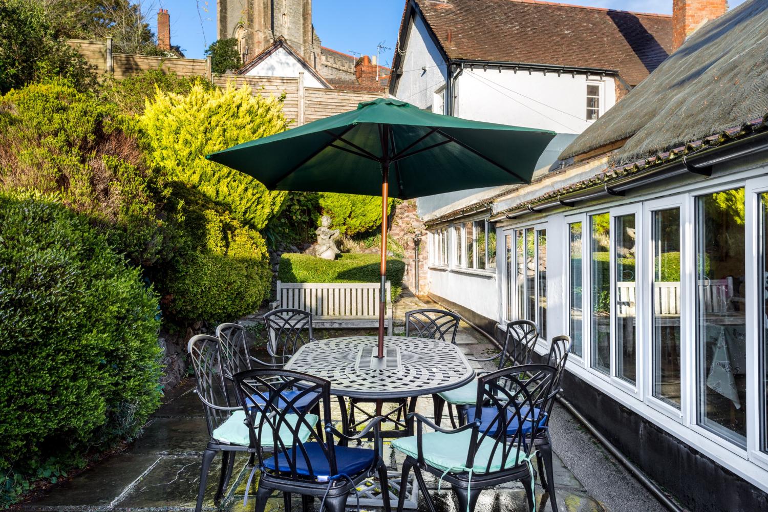 There is a large garden table that seats eight for al fresco dining