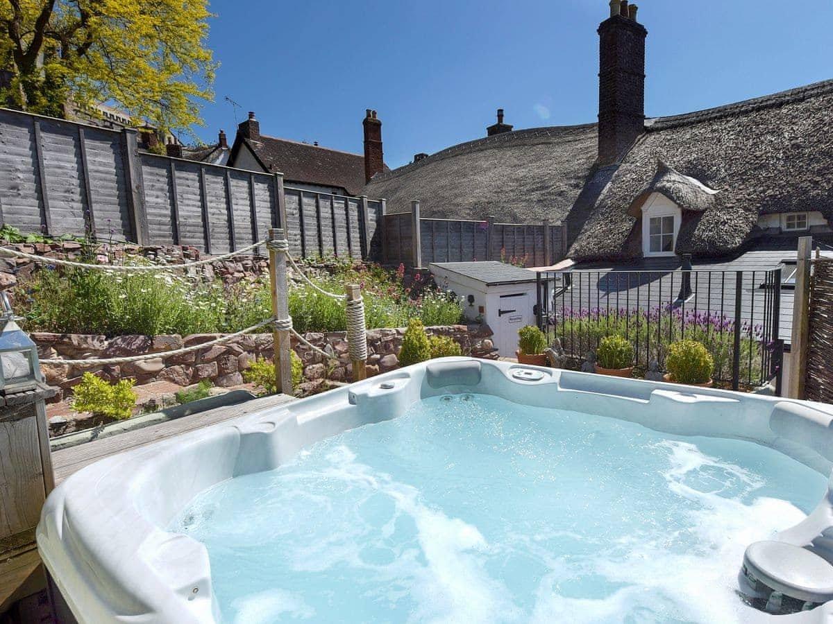 Gorgeous hot tub with views of the cottage and garden.