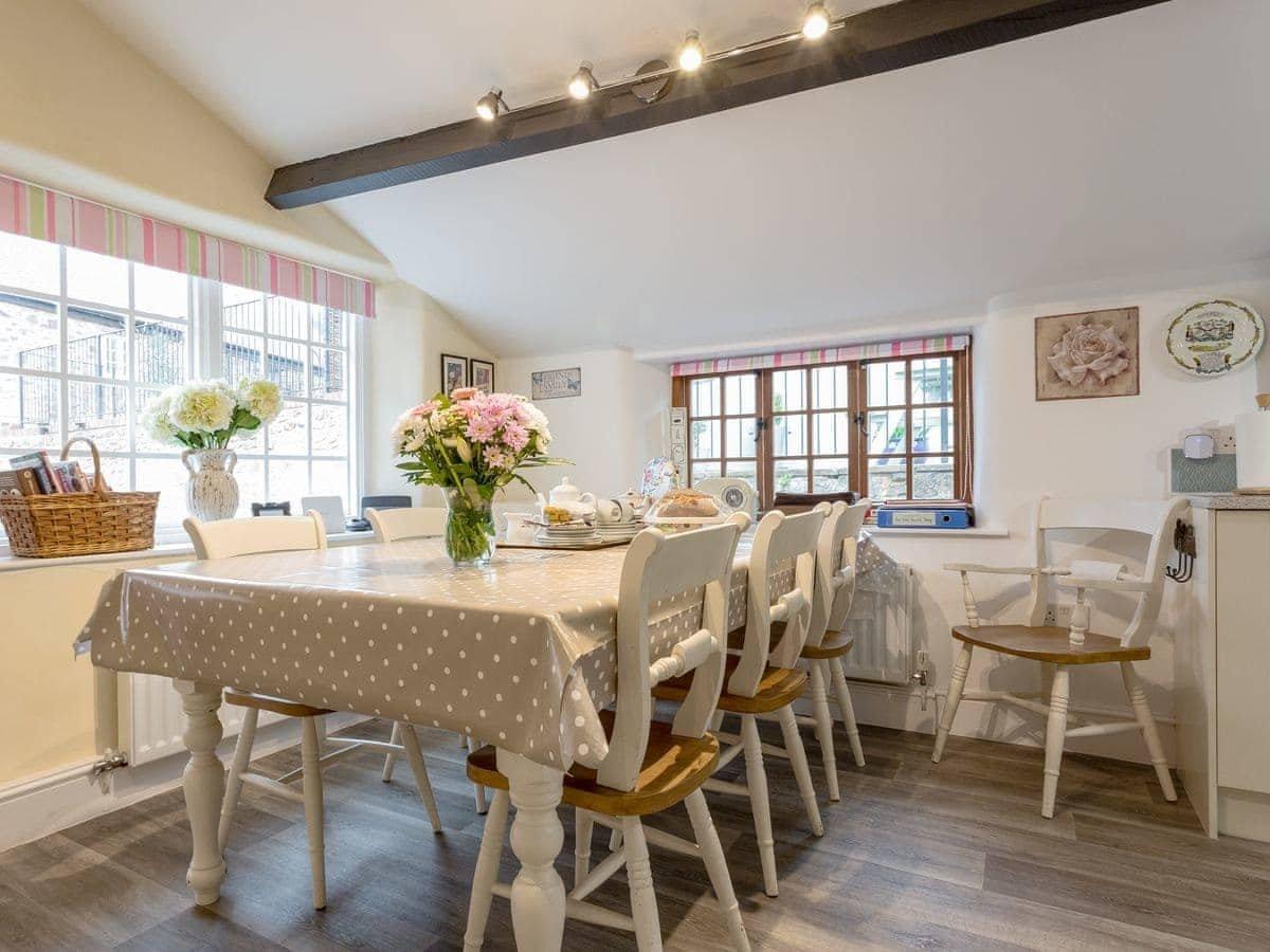 There's a large farmhouse pine dining table in The Old Sweet Shop's kitchen.