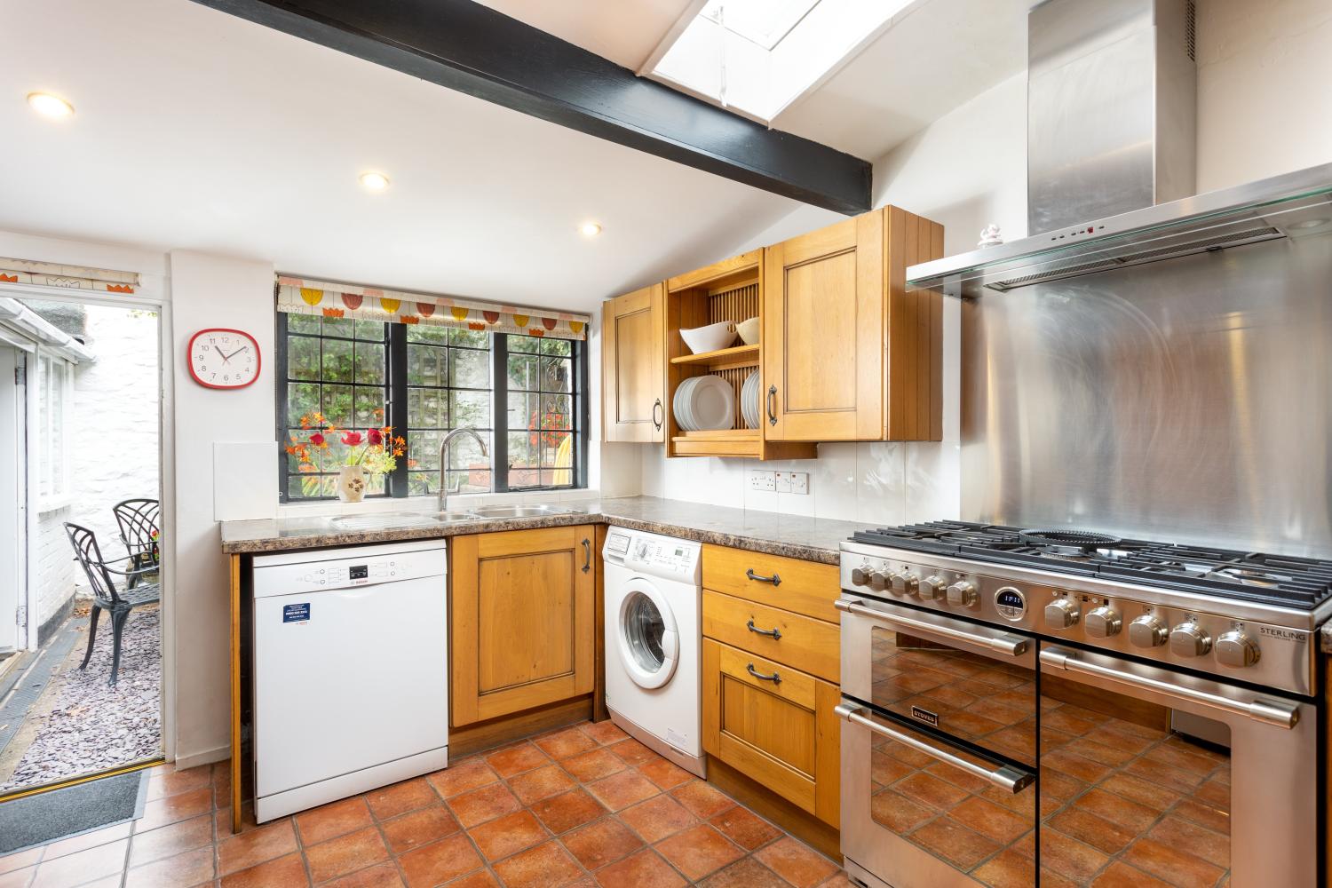 There's a large dual fuel range cooker, washing machine and dishwasher in the kitchen.