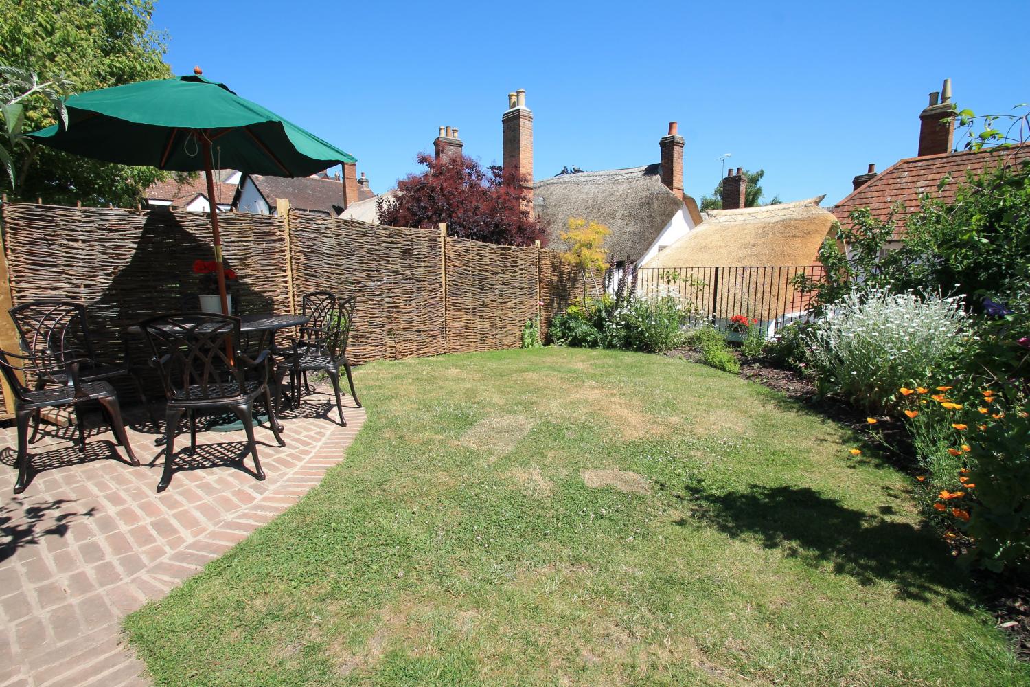 The garden has views over to our two thatched cottages next door (The Old Sweet Shop and Pilgrim Corner).