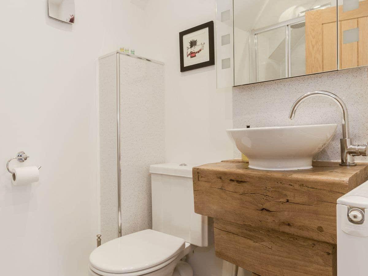 The bathroom used by guests in The Snug has a vanity unit made from old oak beams.