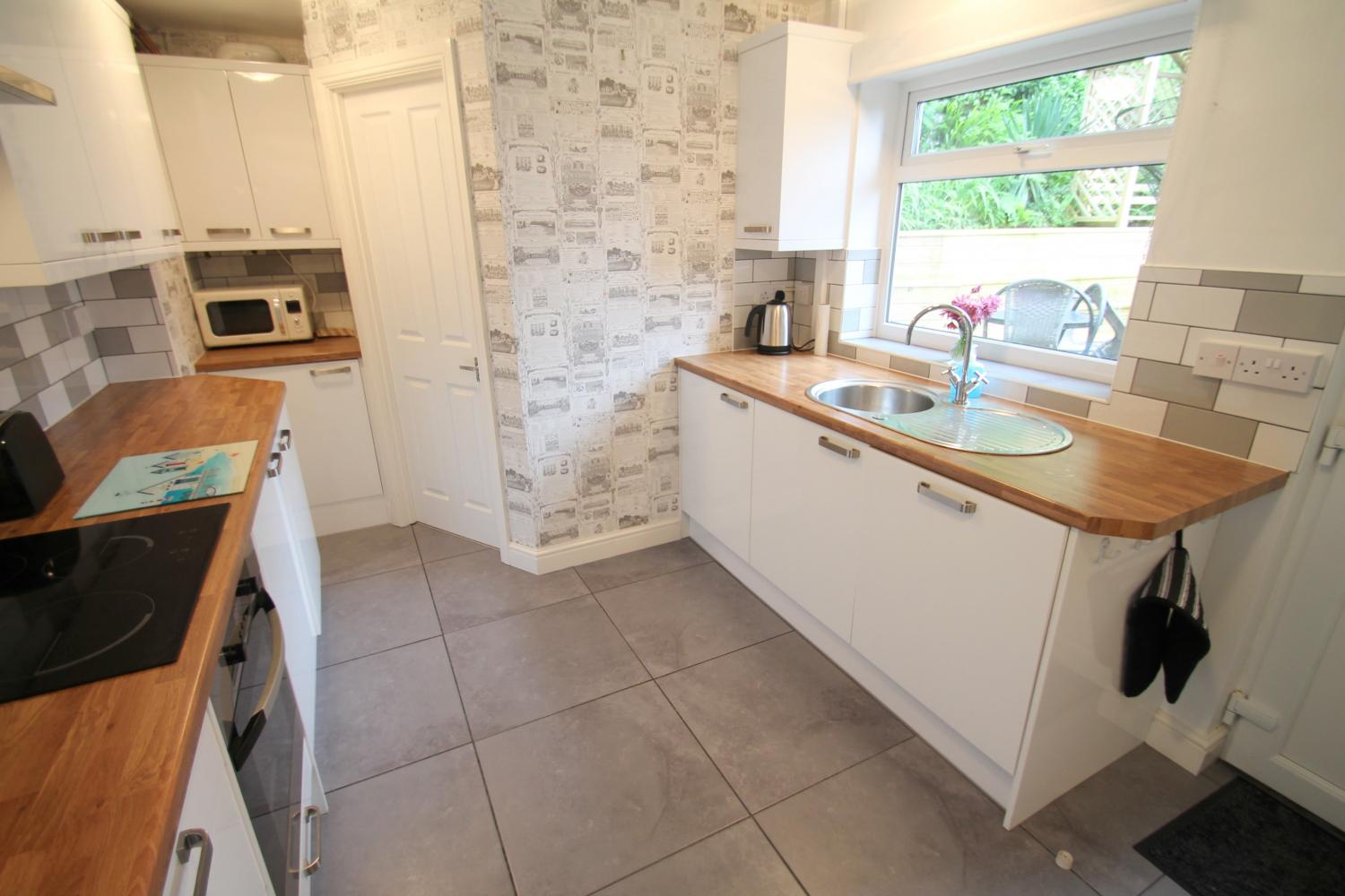 Fully Fitted kitchen opening to decked courtyard