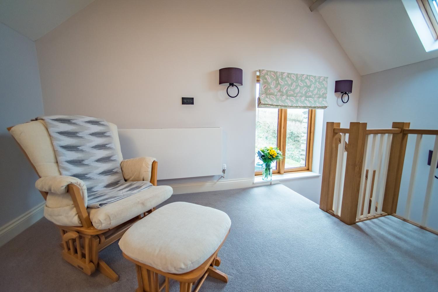 The Cow Shed rocking chair next to the bed