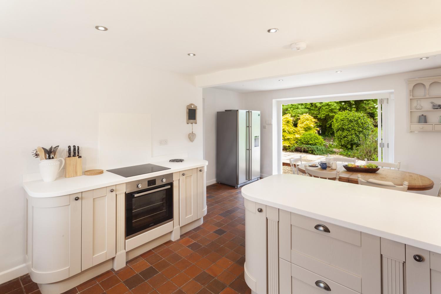 Kitchen with bi-fold doors opening to patio