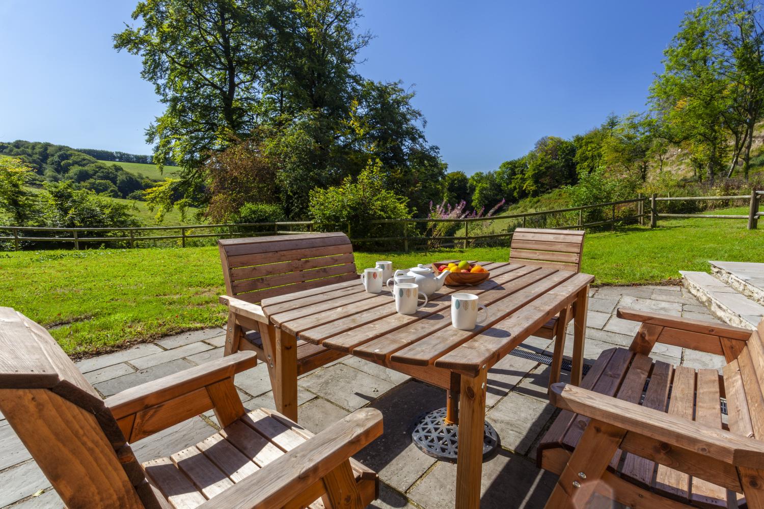 Patio with a combe view at Red Deer Cottage