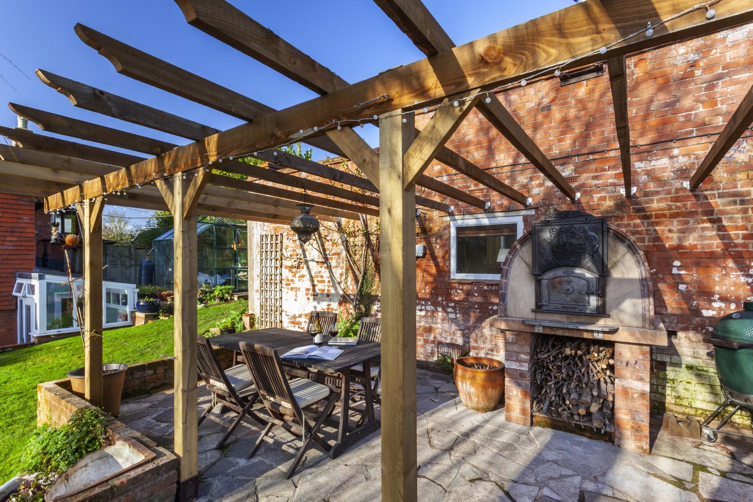 Dining area beneath pergola.