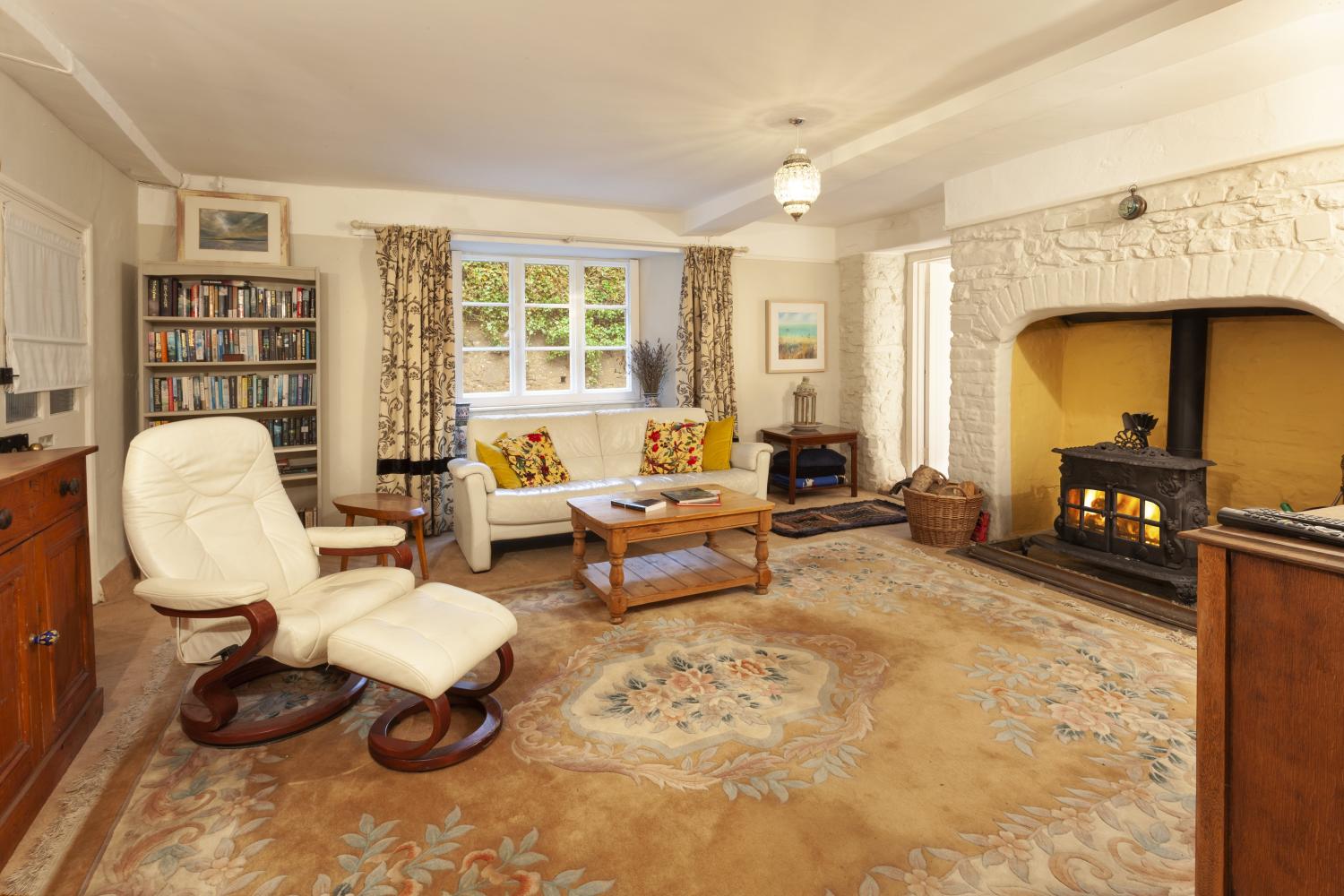 Cosy sitting room with wood-burner and TV