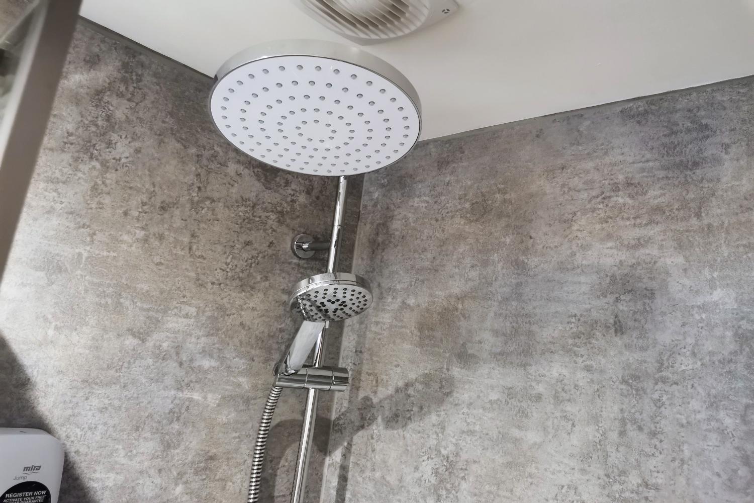 Overhead electric shower in enclosure with sliding door