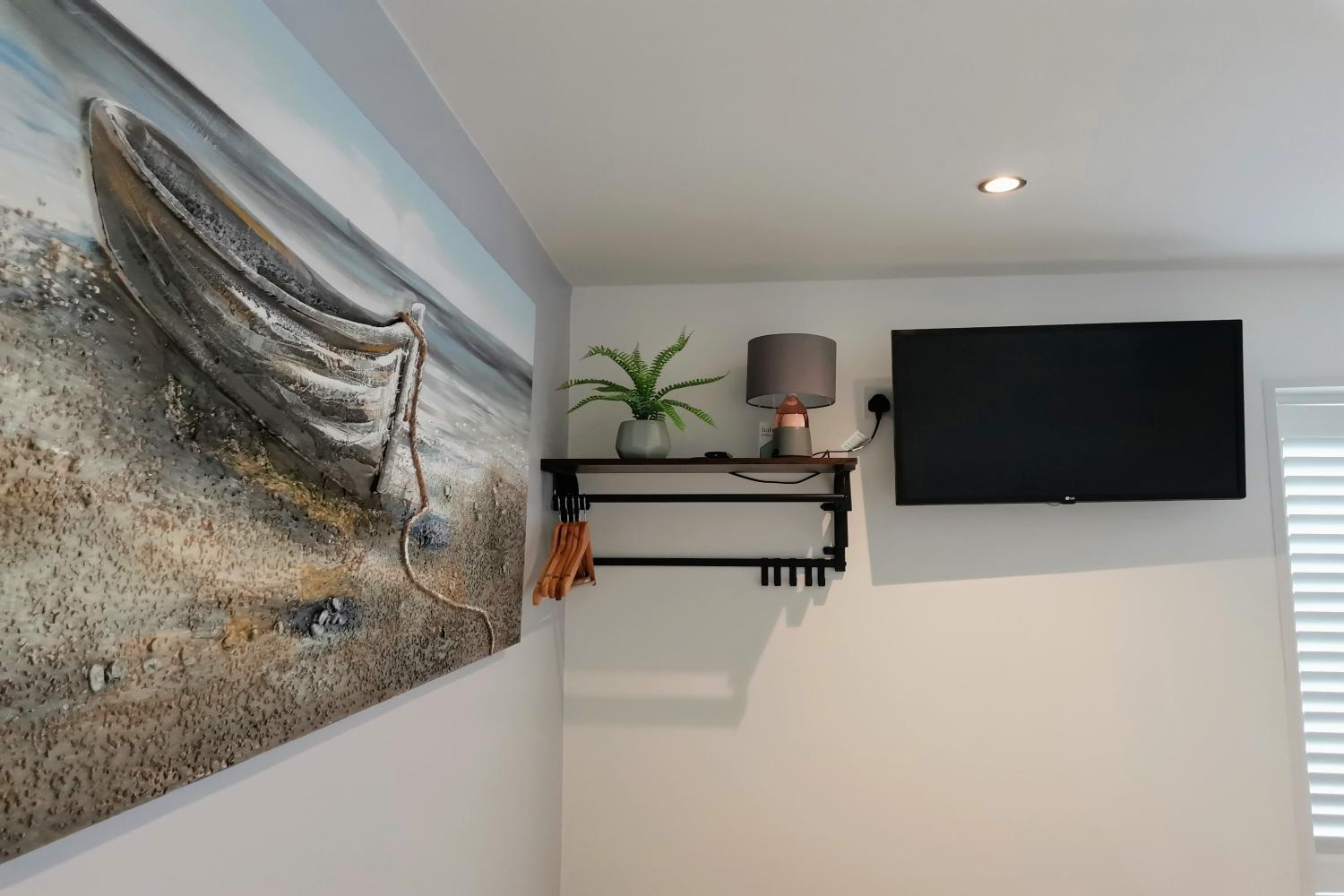 Smart TV, lamp, clothes hanging area