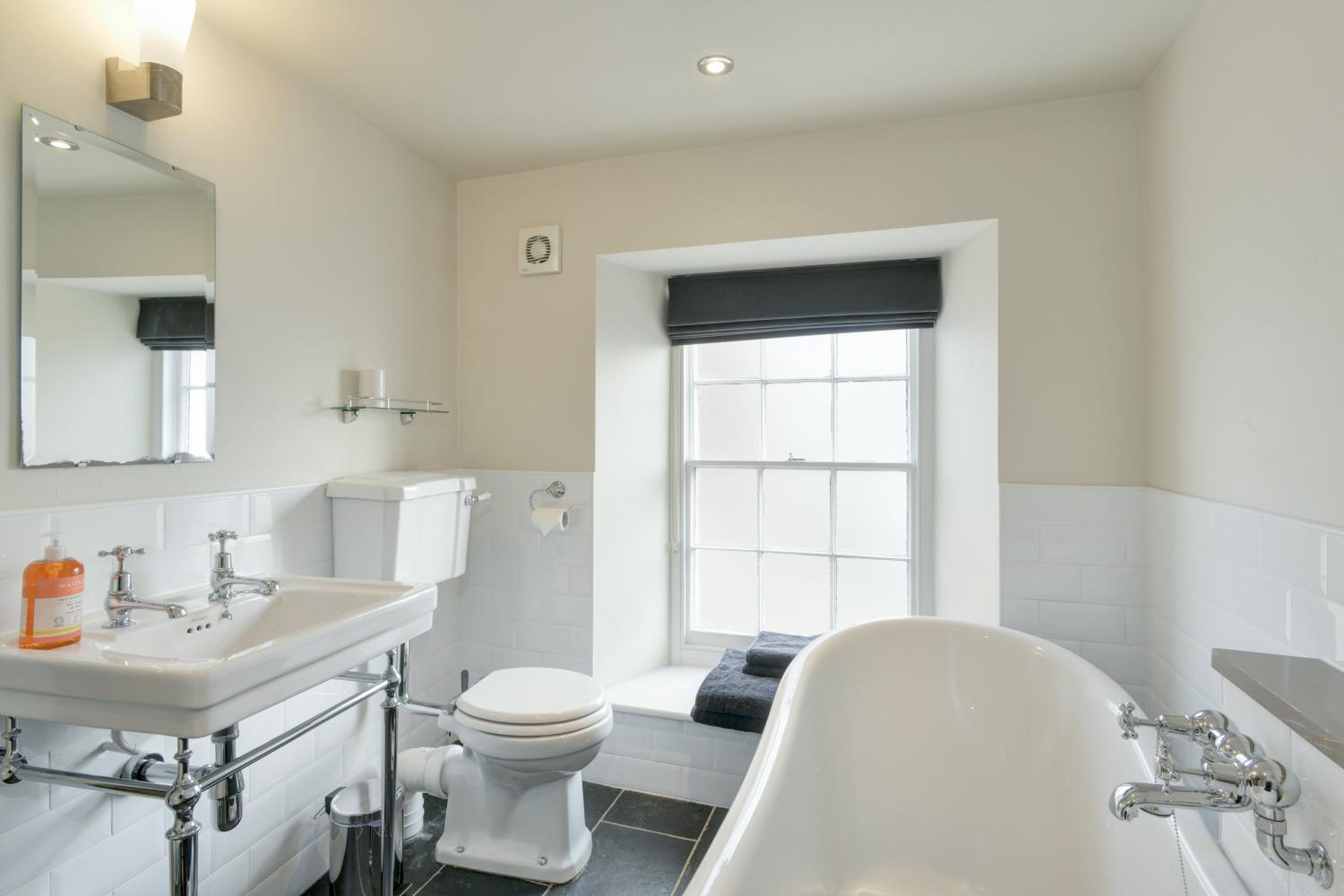 Four en-suite bathrooms with slipper bath and walk-in shower.