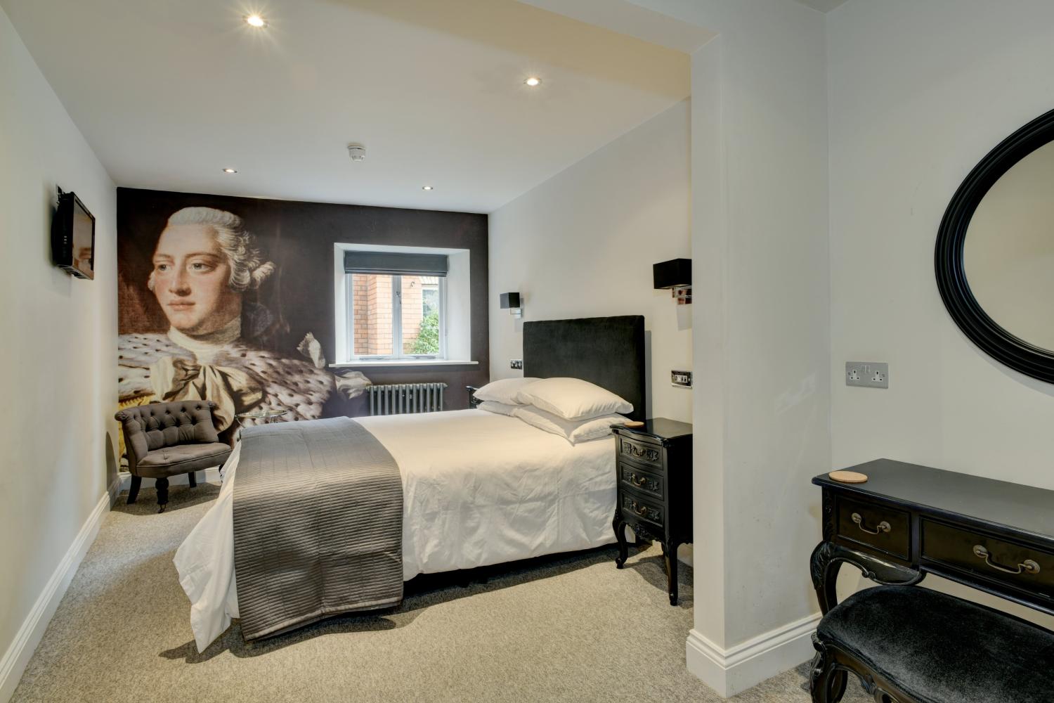 The Kings room. A king sized bed. En-suite bath & shower.