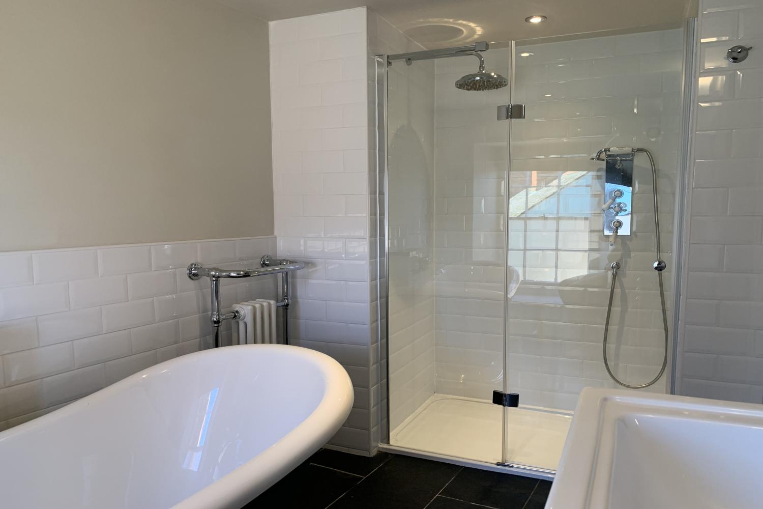 Four en-suite bathrooms with slipper bath and walk-in shower.