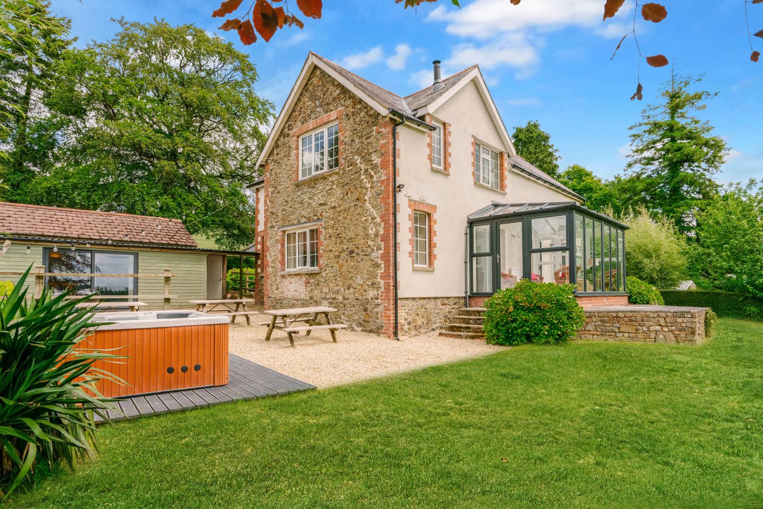 Barton House sleeps 9 The farm House and group dining room to the left