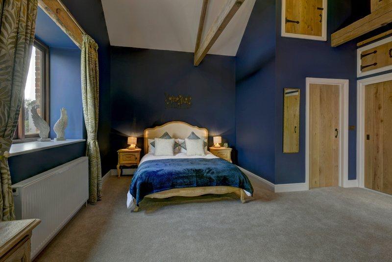 Bedroom 1 has a king size bed with en-suite bathroom and shower over bath