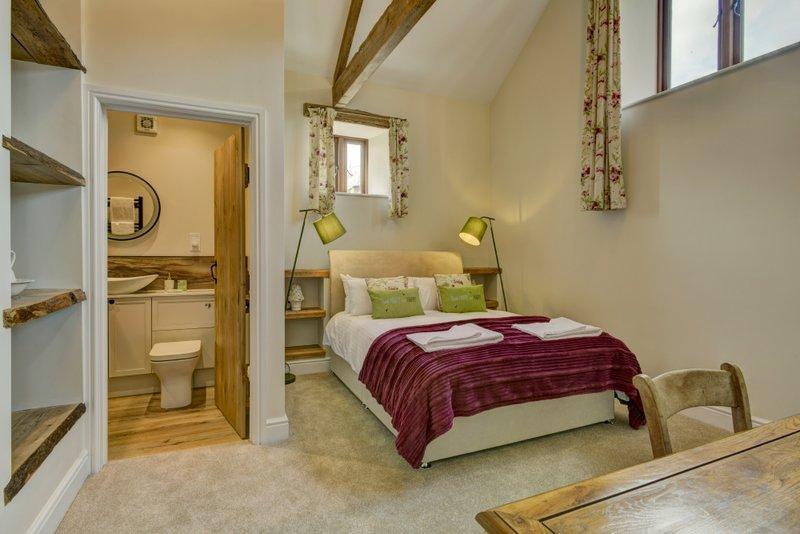 Bedroom 2 has a king sized bed with en-suite shower