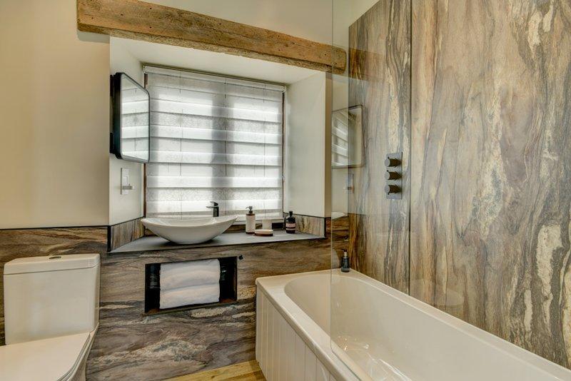 En-suite bathroom 1 with over-bath shower