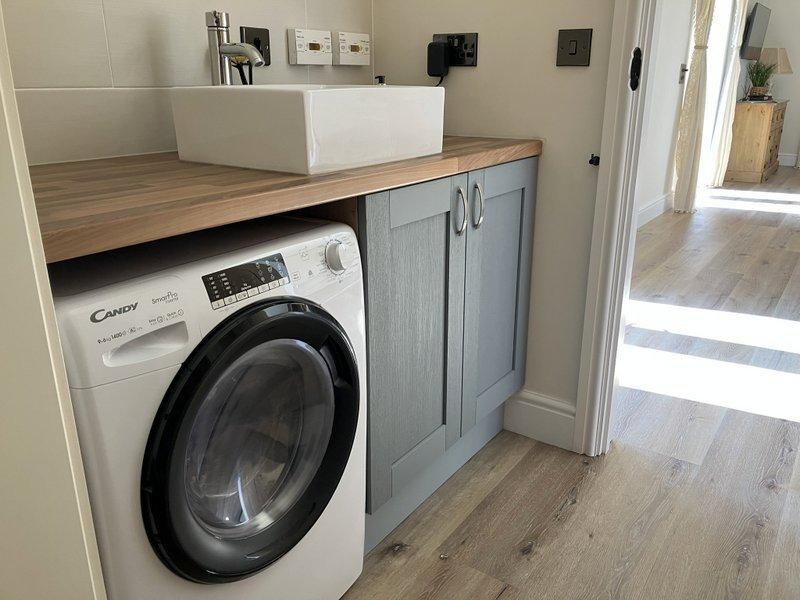 Utility room with washer/dryer, Iron and board and cloakroom