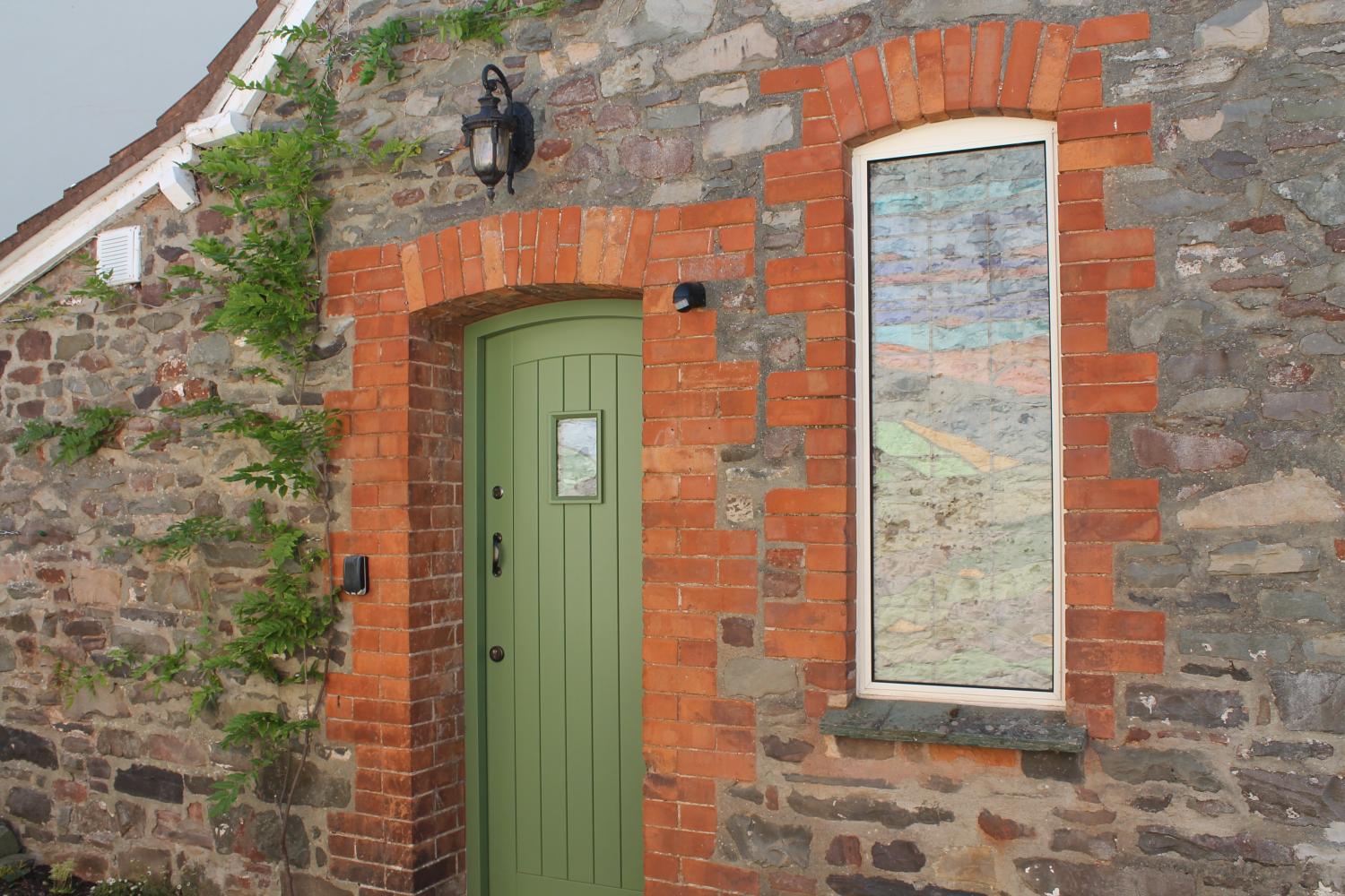 The front door and stain glass window